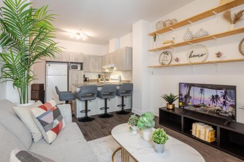 a living room with a couch and a tv at Large Suite in Downtown Montreal in Montréal