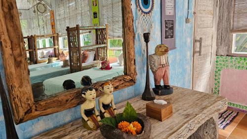 a room with a mirror and some figurines on a table at Lovina Loca in Lovina