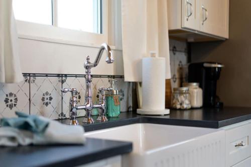a kitchen counter with a sink and aaucet at The Cahill- Magnolia Brewery House c 1894 in Waco