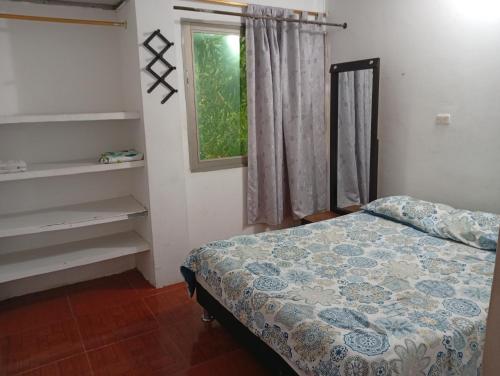 a bedroom with a bed and a window at ApartaEstudio Sunset I in Santiago