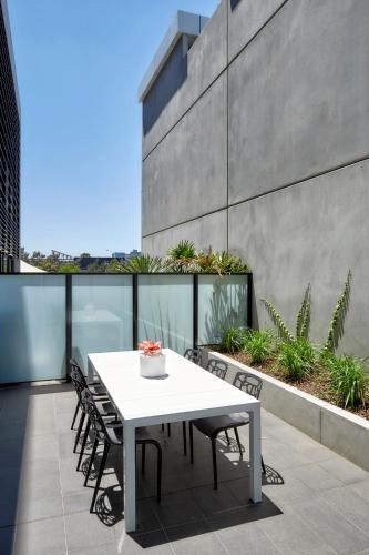 a white table and chairs on a balcony at 381 Cremorne in Melbourne