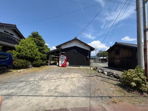 a gas station with a car parked in front of it at 高島市一棟貸切 Biwa Lake琵琶湖 徒歩0分 大人数でご利用だとお得連泊がお得BBQ自転車無料利用可ペット可 in Takashima