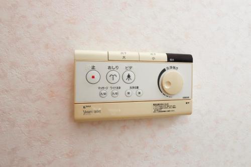 a lightswitch on a wall with at 南伊豆ガーデンヴィラ in Minamiizu