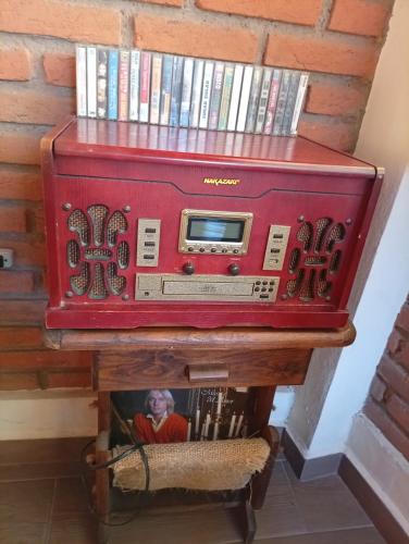 a red suitcase sitting on top of a table with books at "Arte en el desván" Rustic loft - Desván rústico in Tenancingo de Degollado