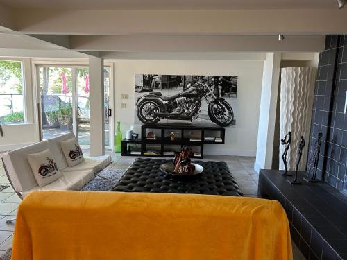 a living room with a motorcycle on the wall at Seymour Private Bedroom, Ensuite Bathroom with Shared Pool, Hot Tub with Views in North Vancouver