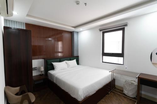 a bedroom with a white bed and a window at Mama Hotel And Apartment - Free Sauna And Gym in Da Nang