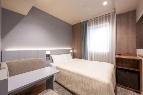 Postel nebo postele na pokoji v ubytování Keio Presso Inn Akasaka