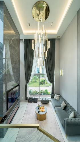 a living room with a blue couch and a chandelier at Eudaimonia Poolvilla Jeju 에다모니아 함덕풀빌라 in Jeju