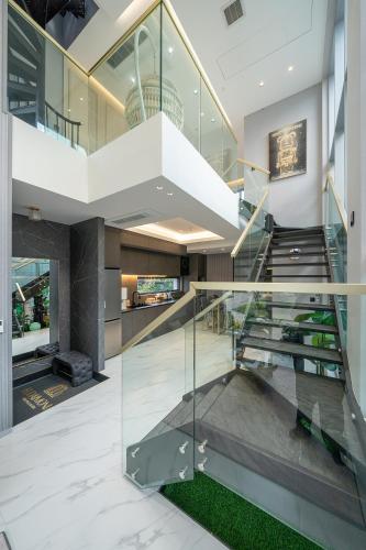 a staircase in a house with glass railing at Eudaimonia Poolvilla Jeju 에다모니아 함덕풀빌라 in Jeju