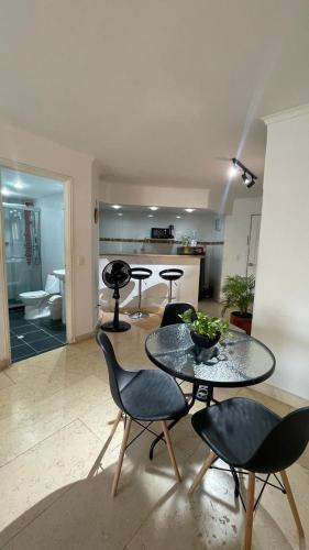 a living room with a table and chairs and a kitchen at Cabrero Beach 1111 in Cartagena de Indias
