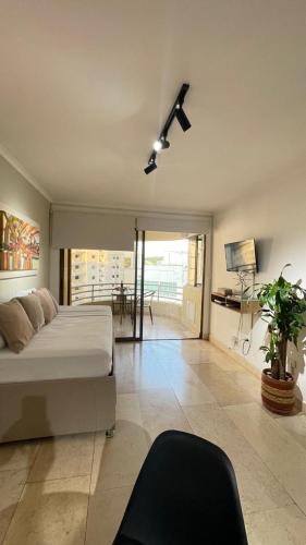 a bedroom with a bed and a ceiling fan at Cabrero Beach 1111 in Cartagena de Indias