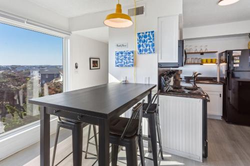 a kitchen with a black table and a large window at C323C - Keep On Duckin' in Duck