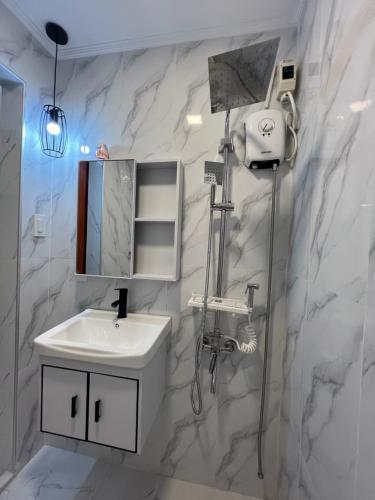 a white bathroom with a sink and a mirror at Compostela Guest Room #3 & Terrace 