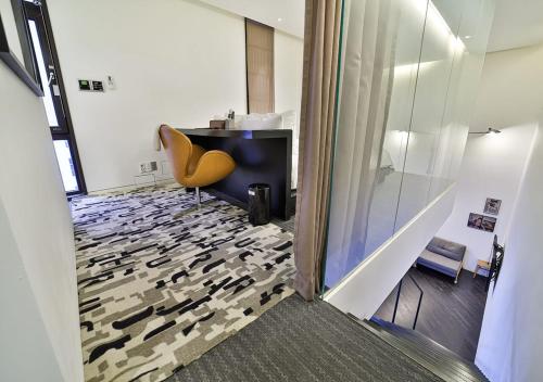 a room with a desk and a yellow chair in a room at JS Boutique Hotel in Hwaseong