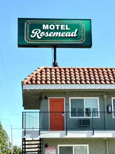 a motel reopened sign on top of a building at Rosemead Motel in Rosemead