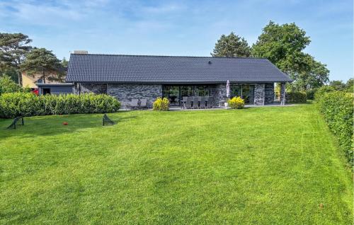 a house with a large lawn in front of it at Amazing Home In Grenaa With Wifi in Grenå
