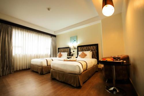 Ένα ή περισσότερα κρεβάτια σε δωμάτιο στο Diamond Suites and Residences