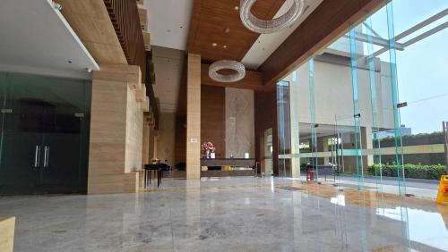 a lobby of a building with a large glass wall at Studio Apartment JiExpo Kemayoran View -Min Stay 3 nights- in Jakarta