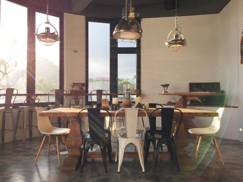 a table and chairs in a room with windows at Minimi Inn-Sailrock Beach House in Eluan
