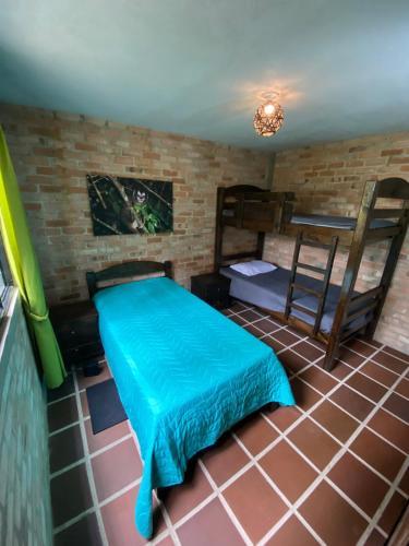 a room with a bed and bunk beds in it at Casa Alto Bonito in Yumbo