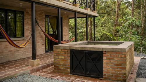 a brick building with a fireplace on a patio at Casa Alto Bonito in Yumbo