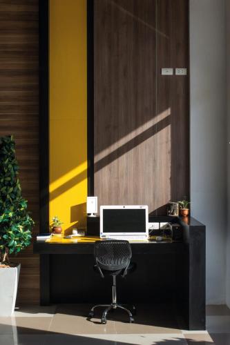 an office with a desk with a computer and a chair at Maison de Cheer in Trang