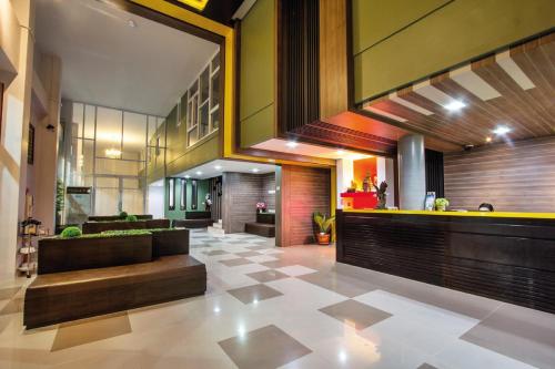 a living room with a couch and a lobby at Maison de Cheer in Trang