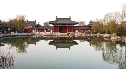 a chinese building with a pond in front of it at Xian Elegant Oriental Hotel in Xi'an