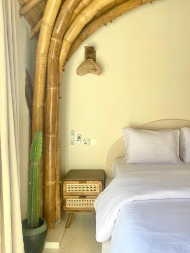 a bedroom with two beds and a cactus at Tipsea Turtle Gili Air in Gili Air