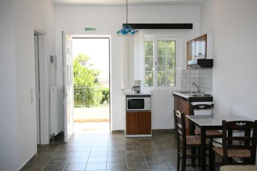 a kitchen with a table and a stove top oven at Villa Carina in Kounopetra