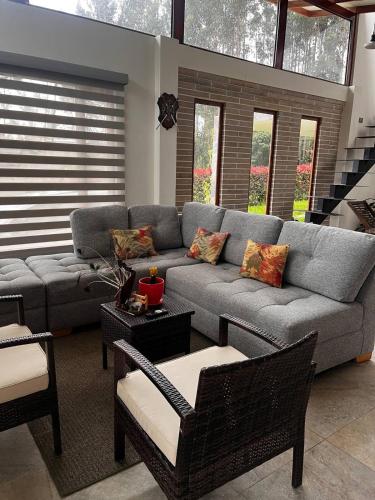 a living room with a gray couch and chairs at Casa de Campo Moderna Ubaté - Sector La Laja in Ubaté