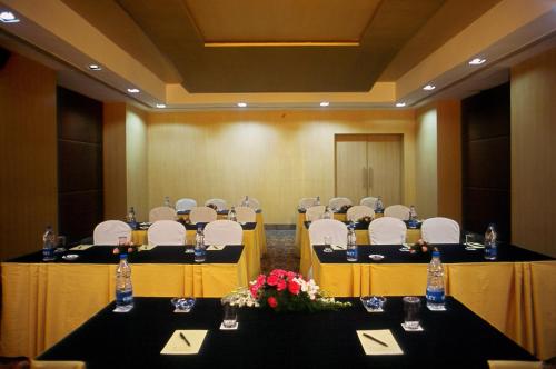 a conference room with tables and chairs and flowers at Katriya Hotel and Tower in Hyderabad