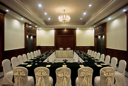 a conference room with a long table and chairs at Katriya Hotel and Tower in Hyderabad