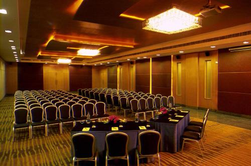 a room with rows of chairs and tables in it at Katriya Hotel and Tower in Hyderabad