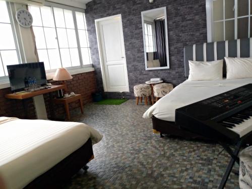 Ένα ή περισσότερα κρεβάτια σε δωμάτιο στο villa Ambarwati
