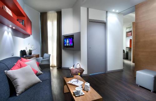 a living room with a couch and a tv at Acapulco Hotel in Cattolica