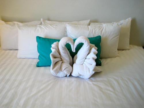 two towels are sitting on top of a bed at Katriya Hotel and Tower in Hyderabad