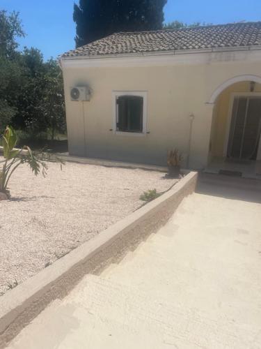 a house with a driveway and a building at Casa Bellina in Evropoúloi