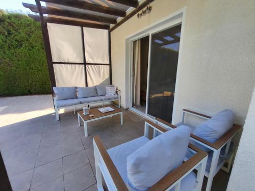 an outdoor patio with a couch and a table at Villa Arfa in Peyia