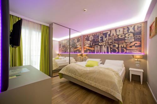 a bedroom with a bed and a painting on the wall at Aktivhotel Santalucia in Nago-Torbole