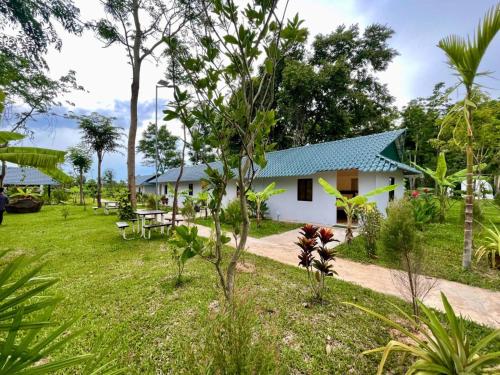 a house in the middle of a garden at Thisak Resort Cheung phnom kulen in Siem Reap