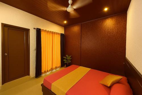 a bedroom with a colorful bed and a window at Hill side Home in Anachal