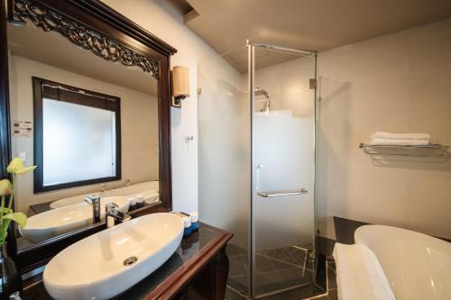 a bathroom with a sink and a glass shower at Anja Beach Resort & Spa in Phu Quoc