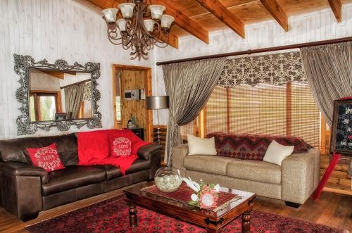 a living room with a couch and a table at Sevens Guesthouse in Kroonstad