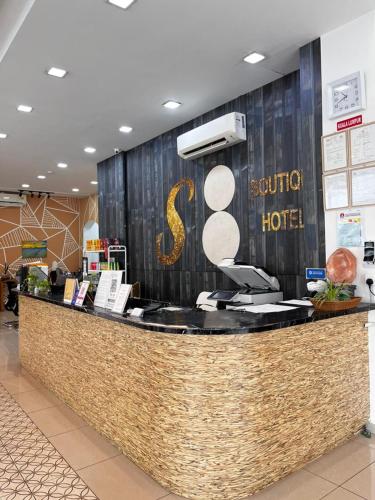 a counter in a store with a sign on it at S8 Boutique Hotel near KLIA 1 & KLIA 2 in Sepang