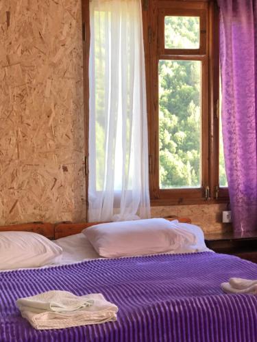 a bedroom with two beds and a window at Ela in Ushguli