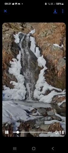a picture of a mountain with snow on it at Nona Guest House in Shilda