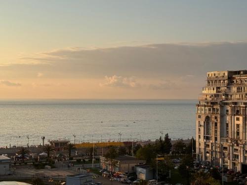 a view of the ocean and a tall building at Annabelle Studio in Batumi