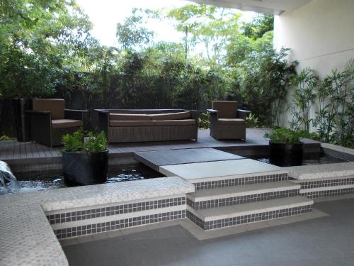 a patio with chairs and a fountain and stairs at Avant Serviced Suites - Personal Concierge in Manila