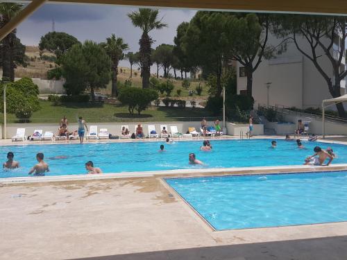 a group of people swimming in a swimming pool at Berksoy Hotel in Bergama